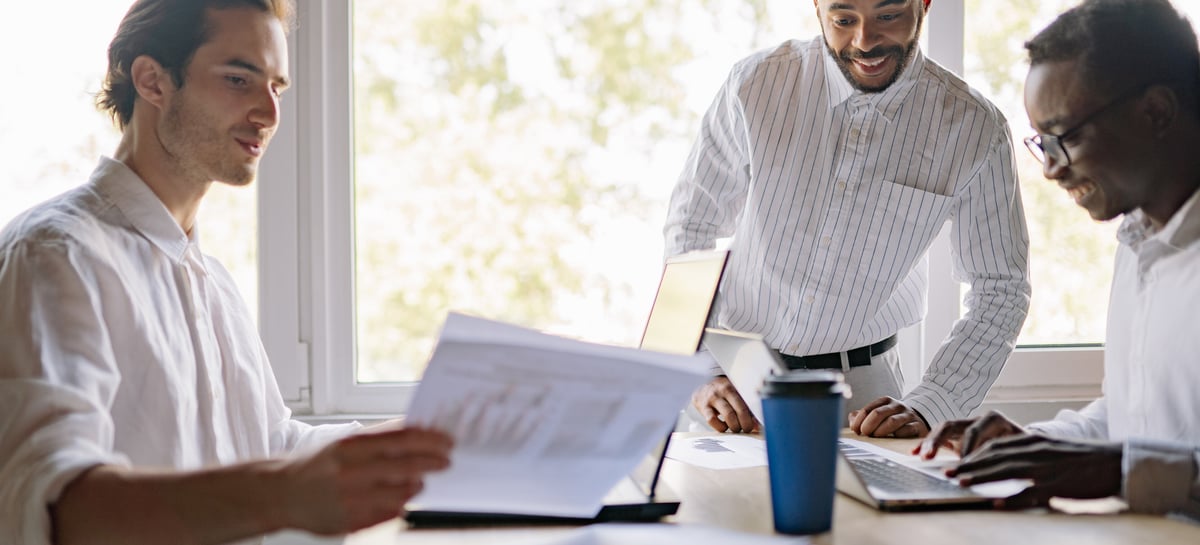 Businessmen reviewing charts email header image