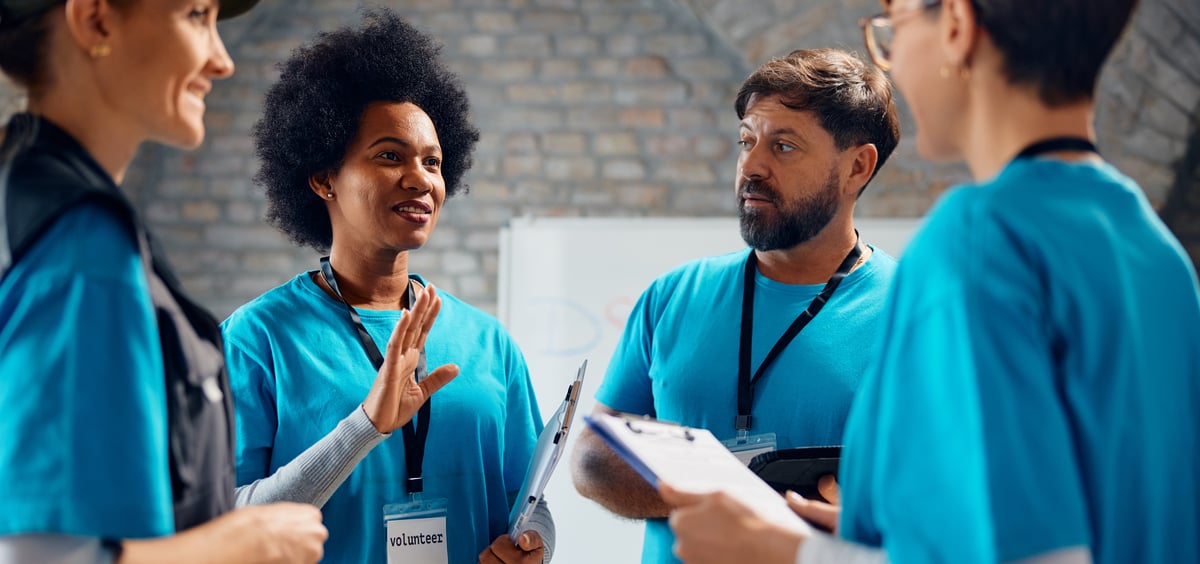 Volunteers in blue shirts email header image